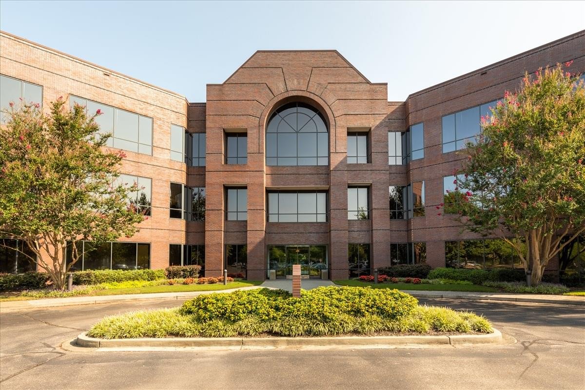 Exterior brick facade and arched entrance of 8295 Tournament Drive.
