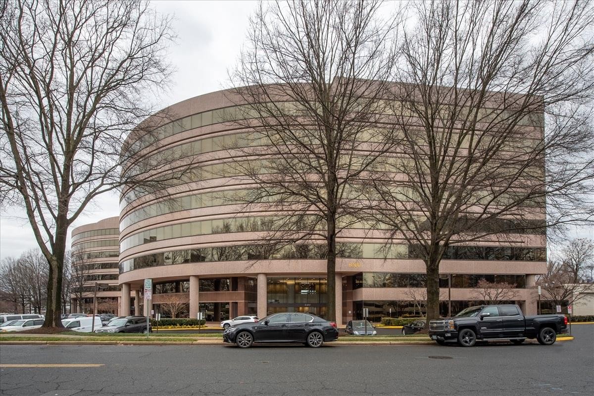 Exterior view of the curved glass facade at 8300 Boone Boulevard Center.