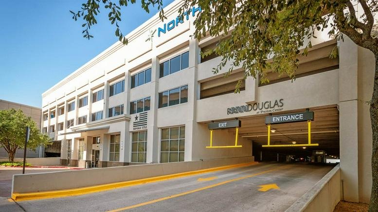 Exterior view of the multi-story white office building at 8300 Douglas Avenue, Suite 800.