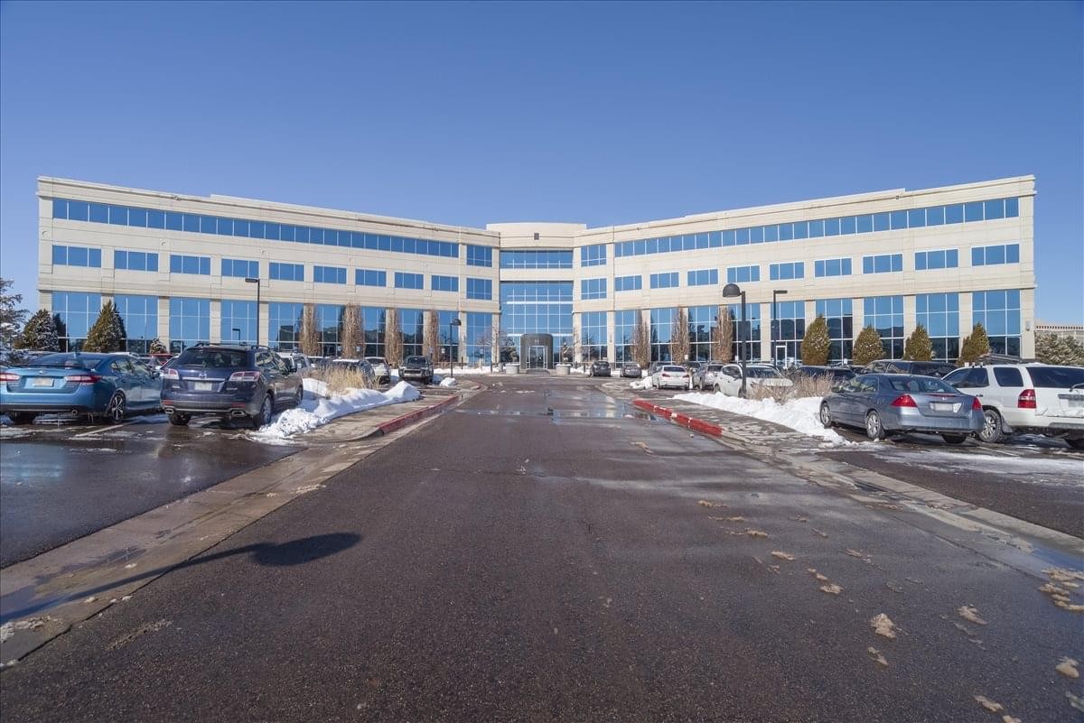 Exterior view of the multi-story glass-fronted office building at The Point at 8310 South Valley Highway.