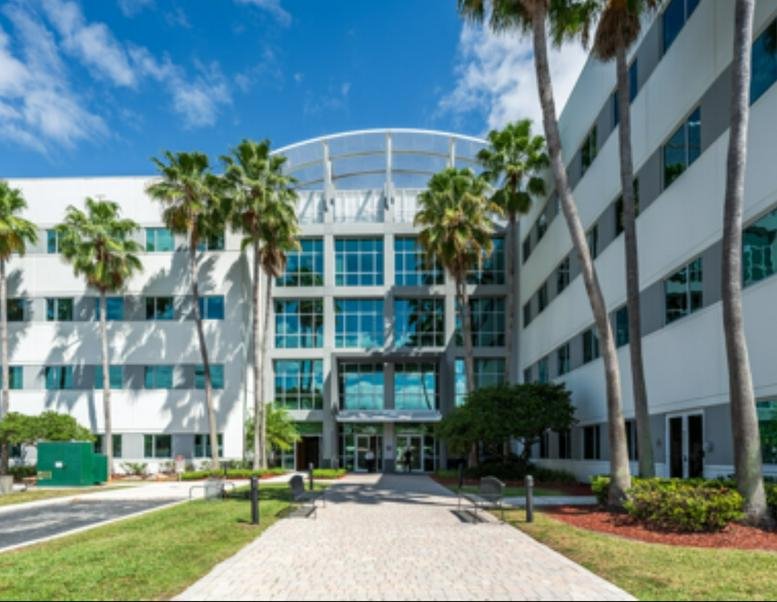 Exterior view of the multi-story glass and concrete office building at 8350 NW 52nd Terrace, 301.