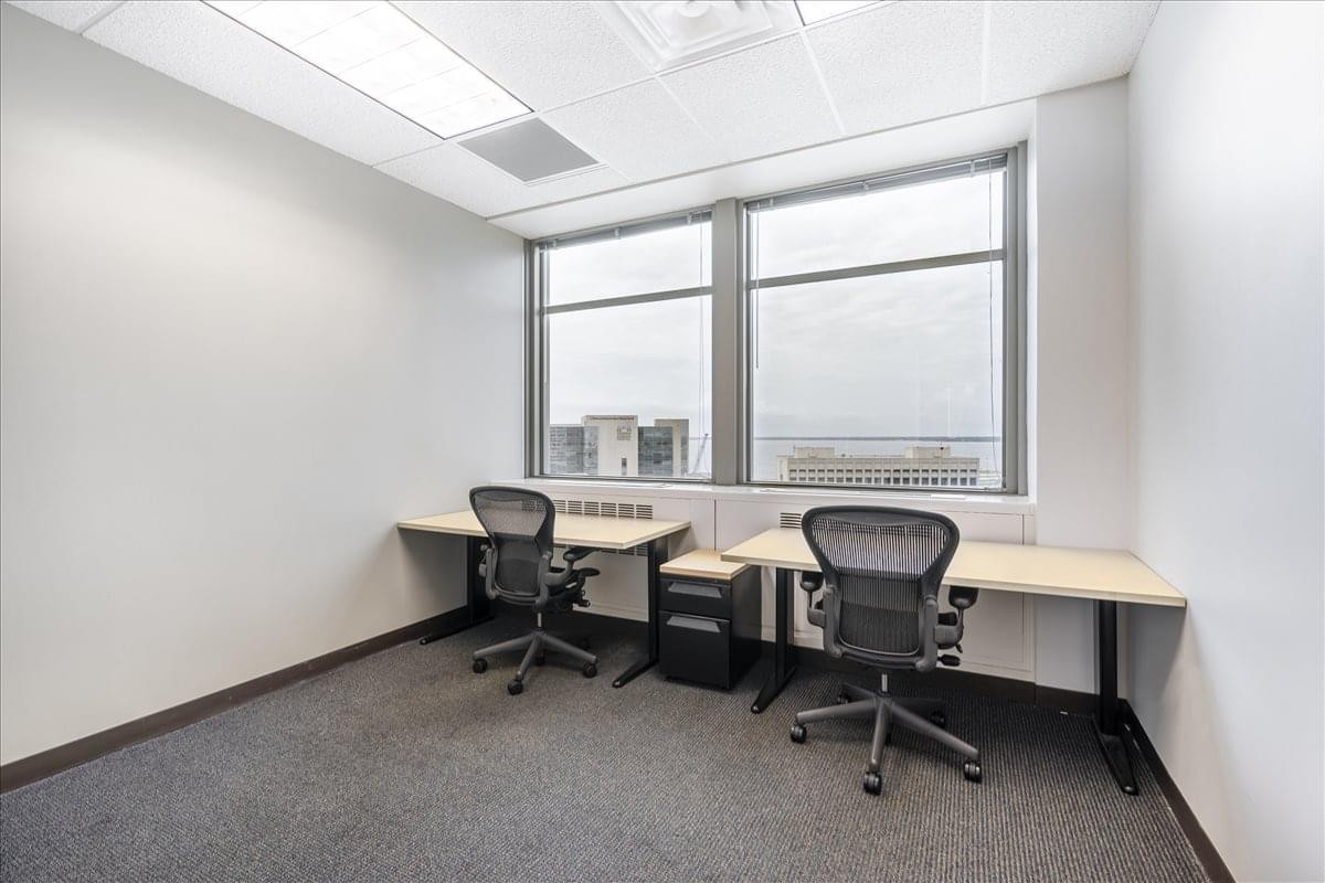 Bright private office suite with two workstations and large windows at 841 Prudential Drive, 12th Floor.