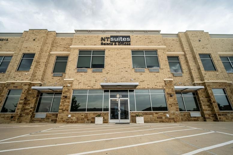 Exterior view of the tan stone facade at 8479 Davis Boulevard, Suite 300.