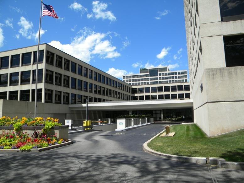 Exterior view of the office building with multiple floors and American flag.