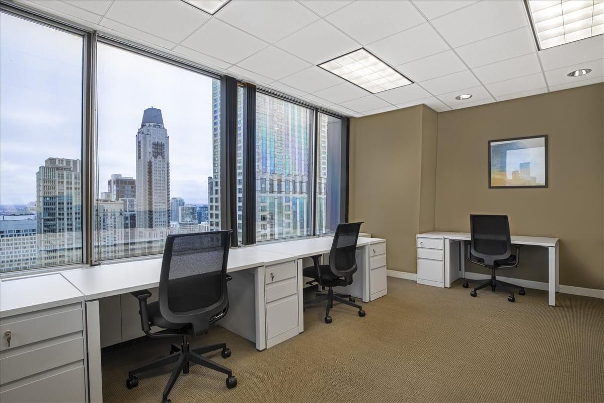 Spacious three-person office suite at John Hancock Center with large windows overlooking the city.