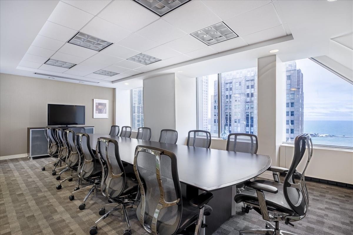 Large professional boardroom at John Hancock Center, 31st Floor, featuring a long table and harbor views.