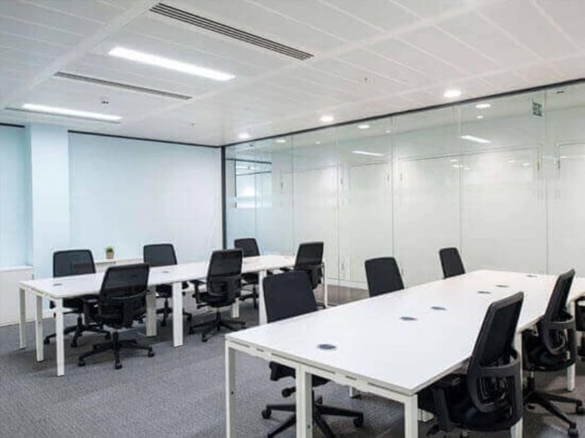 Spacious open-plan workspace at Bankers Hall with white desks and black ergonomic chairs.