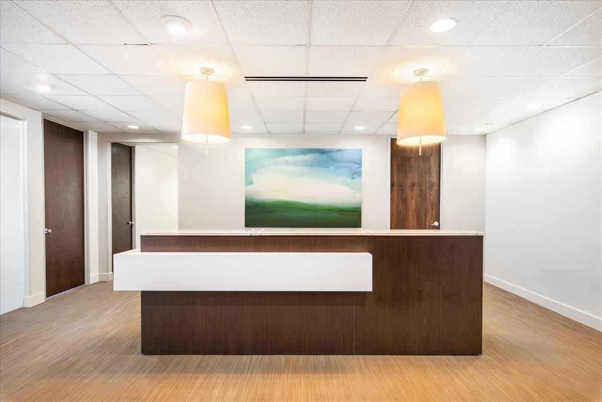 Professional reception desk at Keystone Crossing Center featuring wood accents and abstract art.