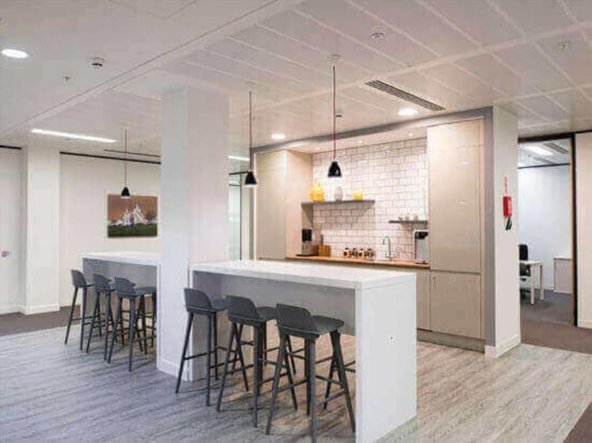 Contemporary office kitchen area at 895 Don Mills Road, Suite 900 with high-top breakfast bars.