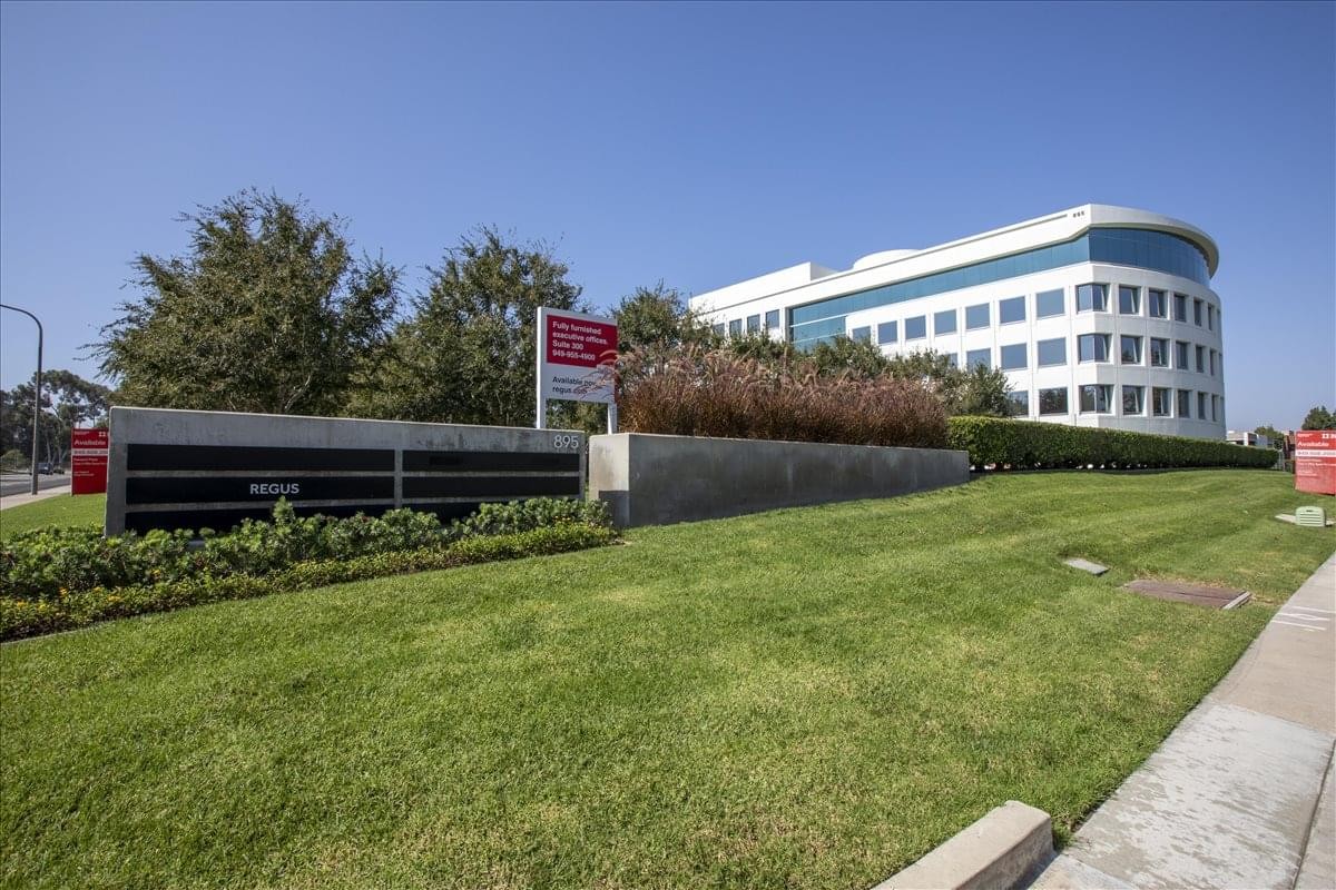 Exterior view of the white curved facade at LNR Newport Plaza Center.