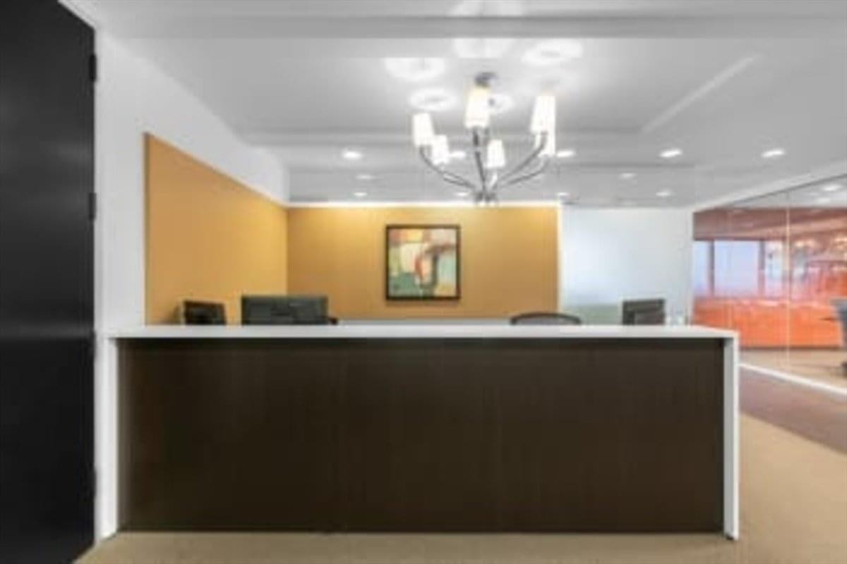 Modern reception desk at 90 Burnhamthorpe Road West, Suite 1400, Sussex Center with a warm wooden feature wall.