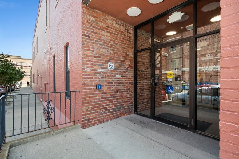 Exterior brick entrance and glass facade at 900 Sarah Street, South Side, Pittsburgh.
