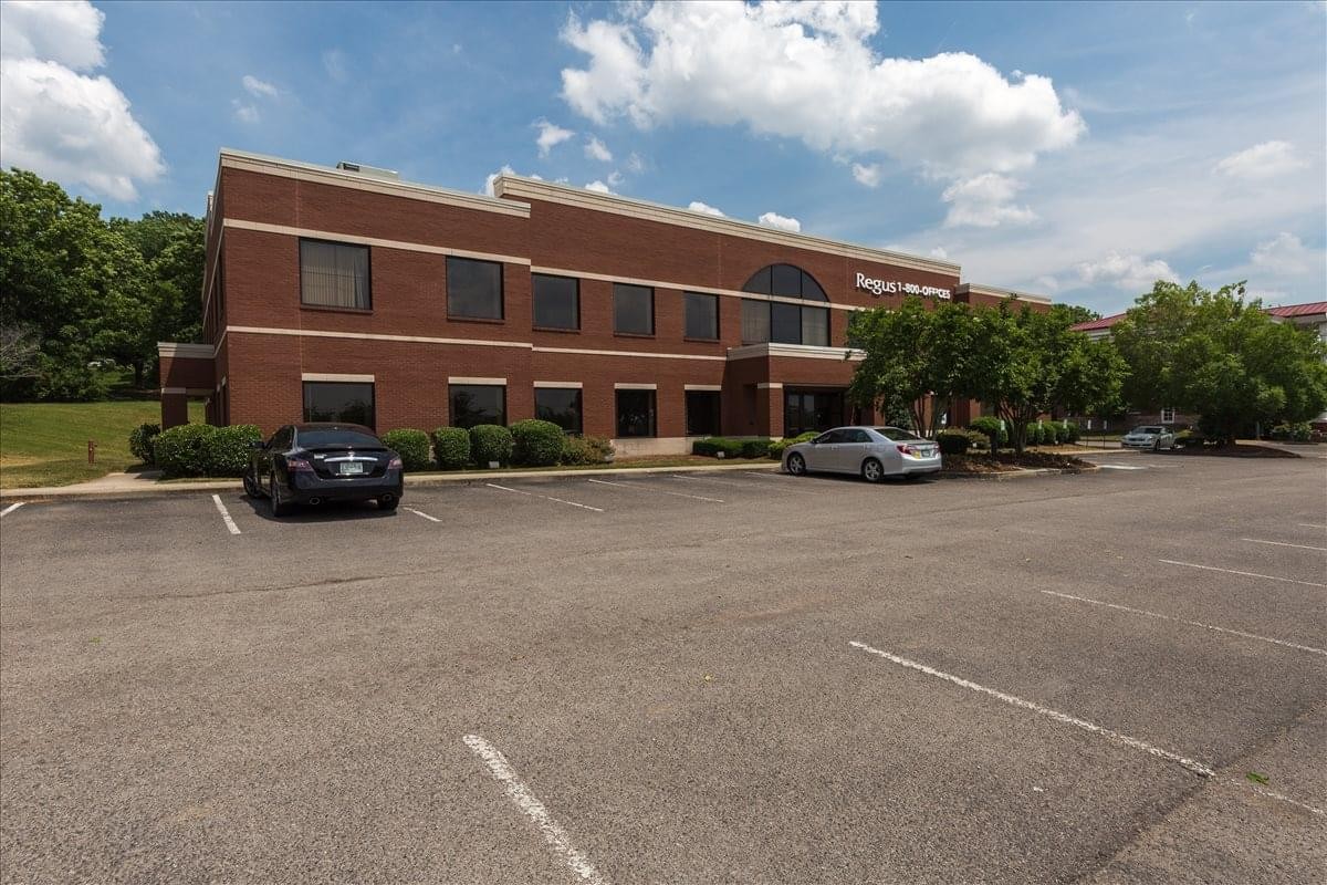 Brick exterior and parking area of the 9005 Overlook Boulevard office building.