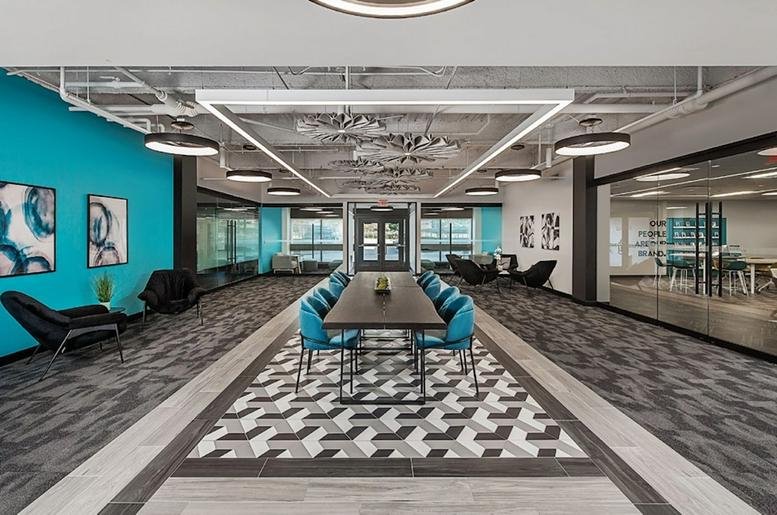 Spacious communal lounge with blue accent wall and modern seating arrangements.