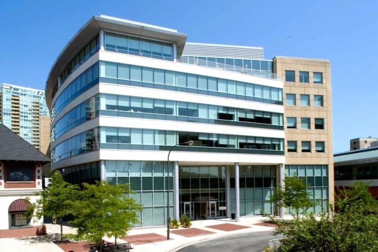 Exterior view of the modern glass and stone building at Industrious at Evanston, 909 Davis Street.