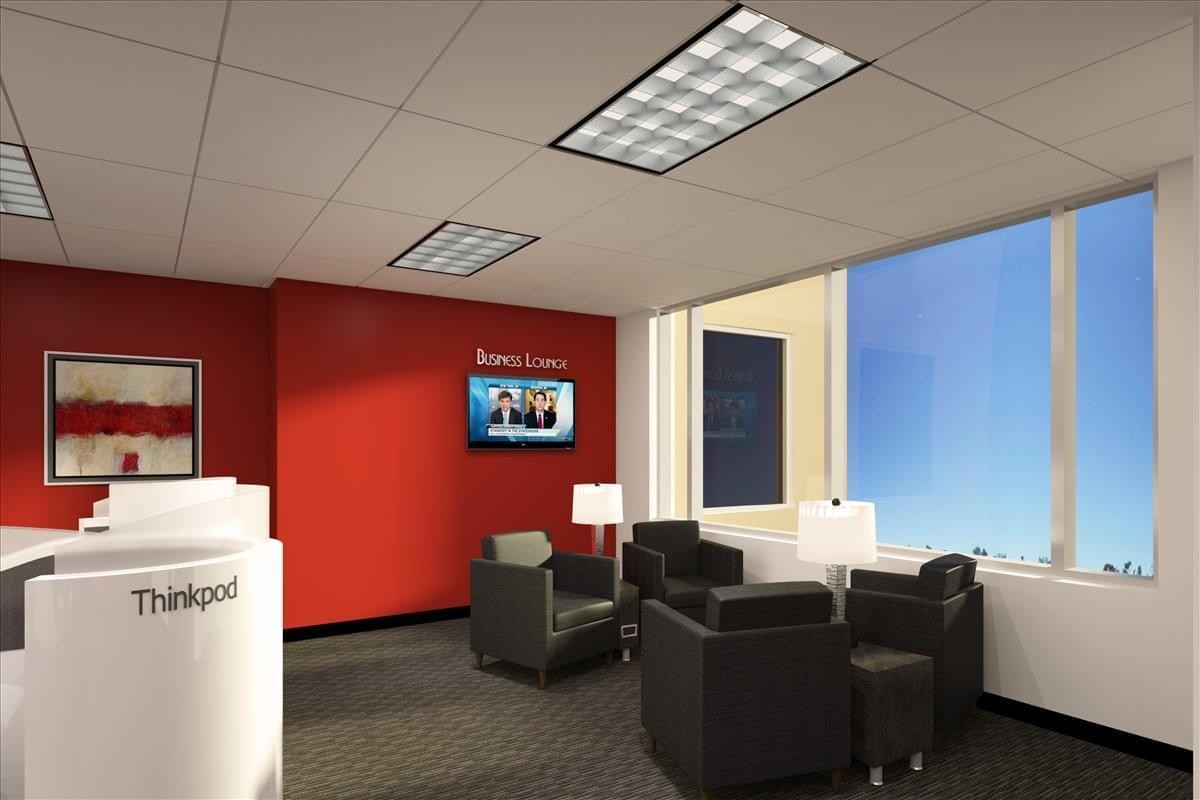 Bright reception waiting area at 9160 Forum Corporate Parkway, Suite 350 with red feature wall and leather chairs.