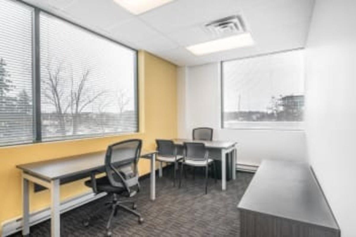 Spacious private office with large windows and yellow accent wall at 9225 Leslie Street, Richmond Hill Center.
