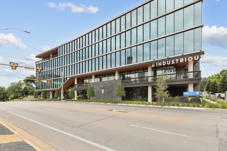 Exterior view of the modern glass-facade building for Industrious E. 7th St. at 924 E 7th Street.