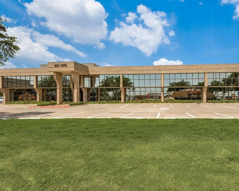 Exterior view of the tan brick and glass building at 9304 Forest Lane.