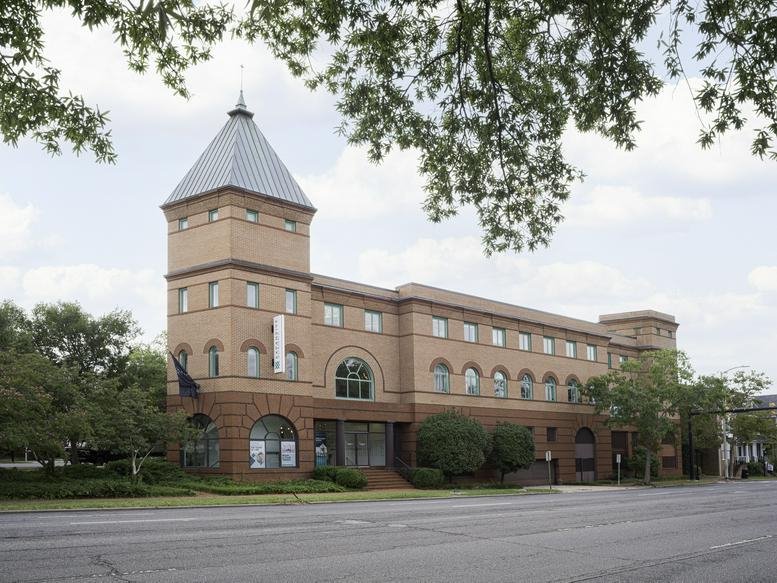 Exterior view of the brick facade and peaked tower at 950 N Washington Street, Alexandria.