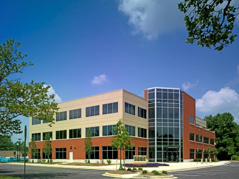 Exterior view of the brick and glass facade at 9520 Berger Road, Suite 212.