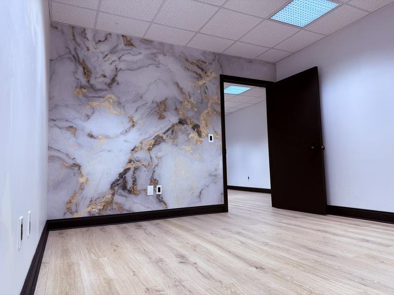 Office suite at 960 Reservoir Avenue, Unit 27, Cranston, Rhode Island with marble wall and open doorway.