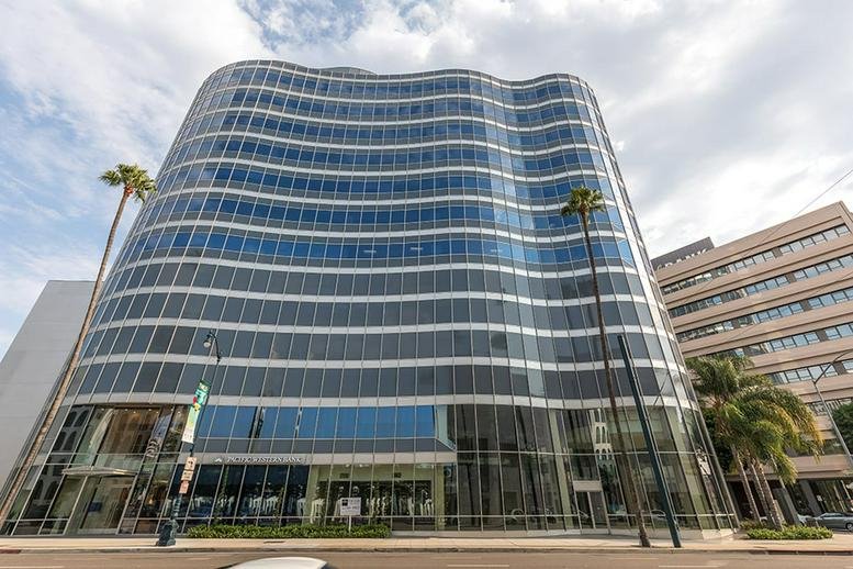 Exterior view of the curved glass facade at 9701 Wilshire Blvd. , Suite 1000.