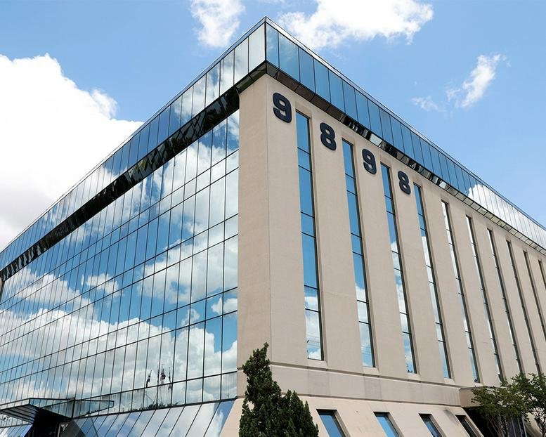 Exterior view of the glass and stone facade at 9898 Bissonnet Street.