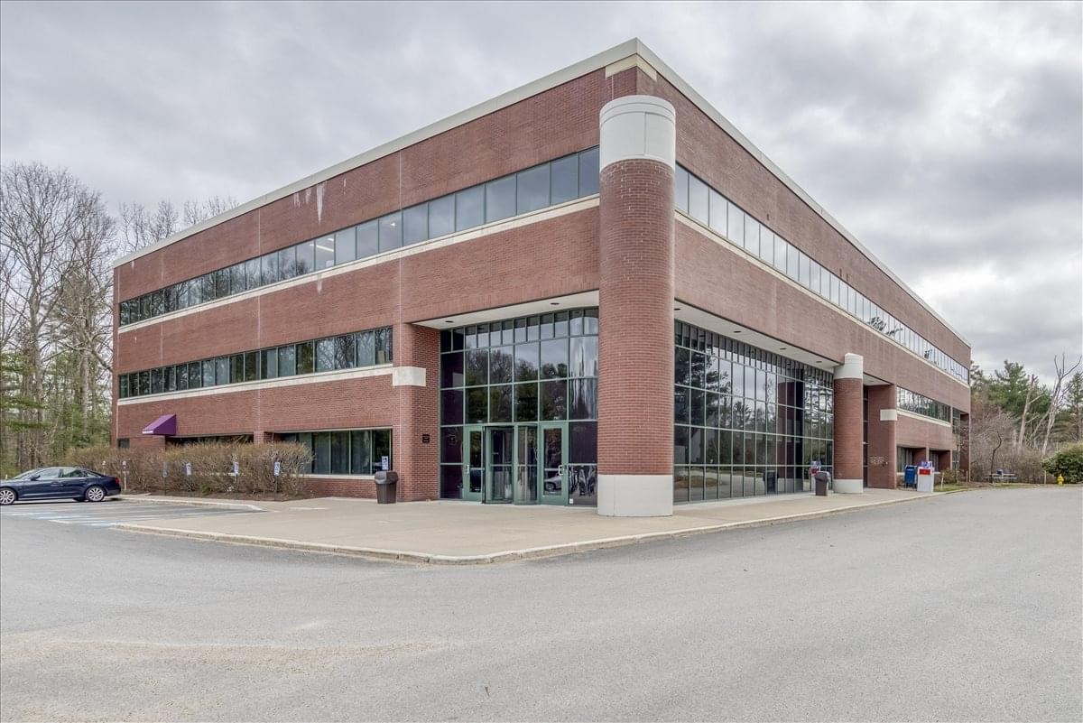 Exterior brick and glass facade of the 99 Derby Street, Suite 200 building.