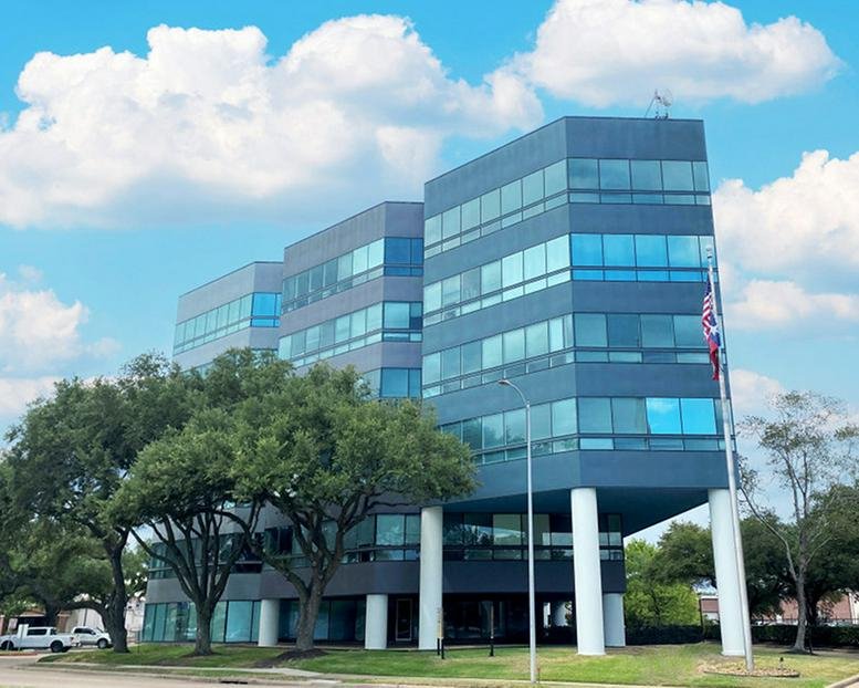 Exterior view of the modern glass-fronted office building at 9950 Westpark Drive.
