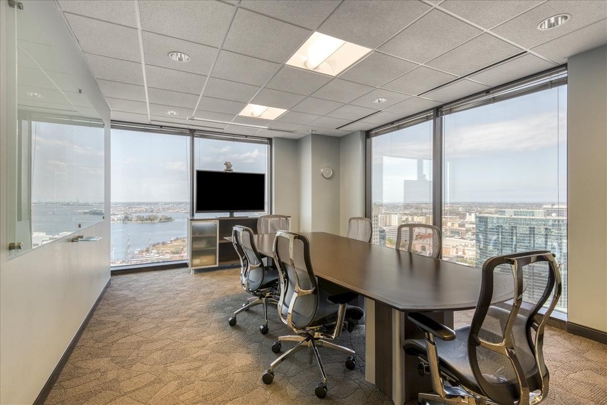 Spacious boardroom at 999 Waterside Drive with floor-to-ceiling windows and waterfront views.