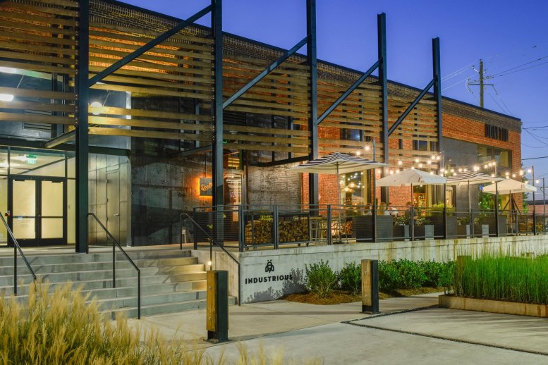 Exterior view of the industrial-style Stockyards, 976 Brady Avenue, Suite 100 with an outdoor patio.