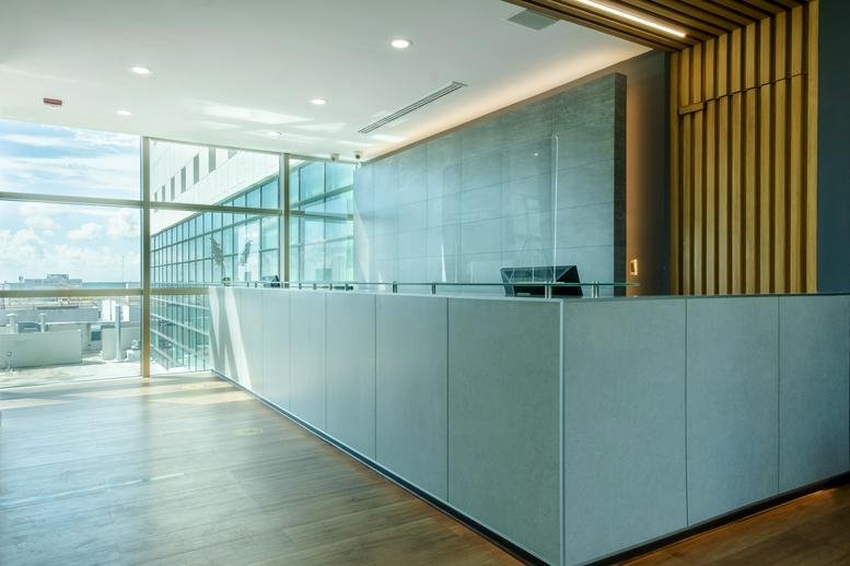 Modern lobby area at Av. Acanceh Manzana 2 Lote 3 Piso 3-B SM 11 with glass desk and city views.