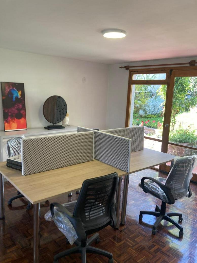 Spacious open-plan workspace at Colibrí Garden Haus with natural light and garden views.
