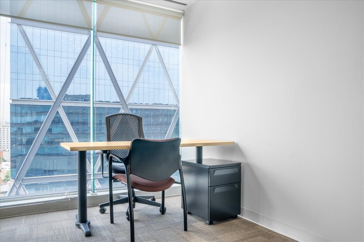 Bright private office suite at Av. Patriotismo 229 with floor-to-ceiling city views.