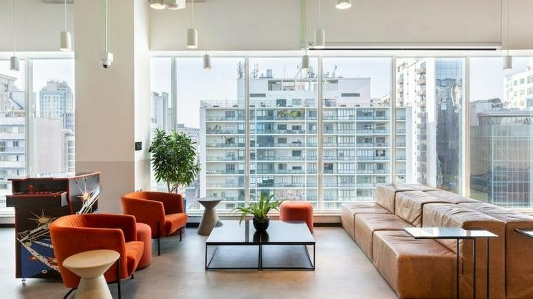 Lounge area with orange armchairs and city views at Av. Paulista, 2537, Bela Vista, São Paulo, Sao Paulo.