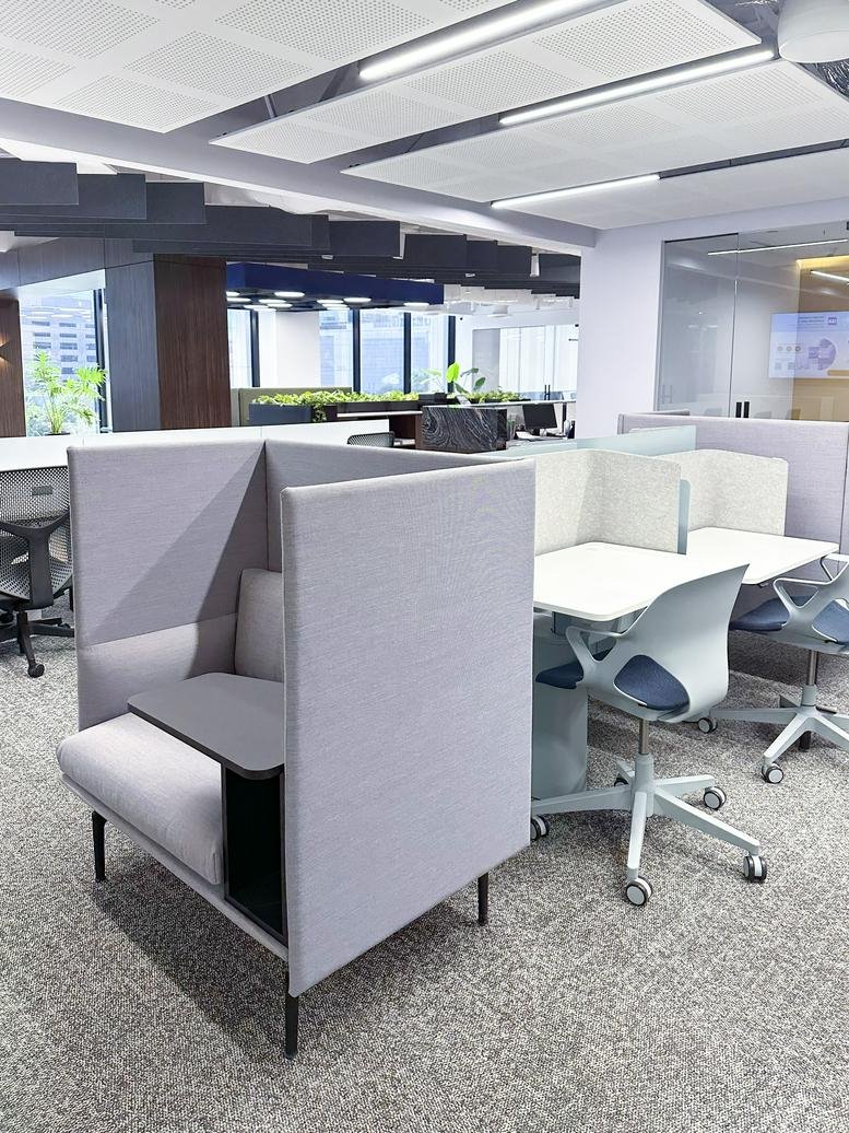 Long boardroom table with black mesh chairs and integrated power outlets.