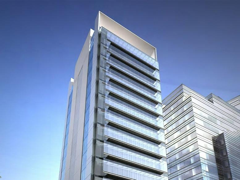 Exterior view of the contemporary glass facade building at Avenida Miguel de Cervantes Saavedra 233.