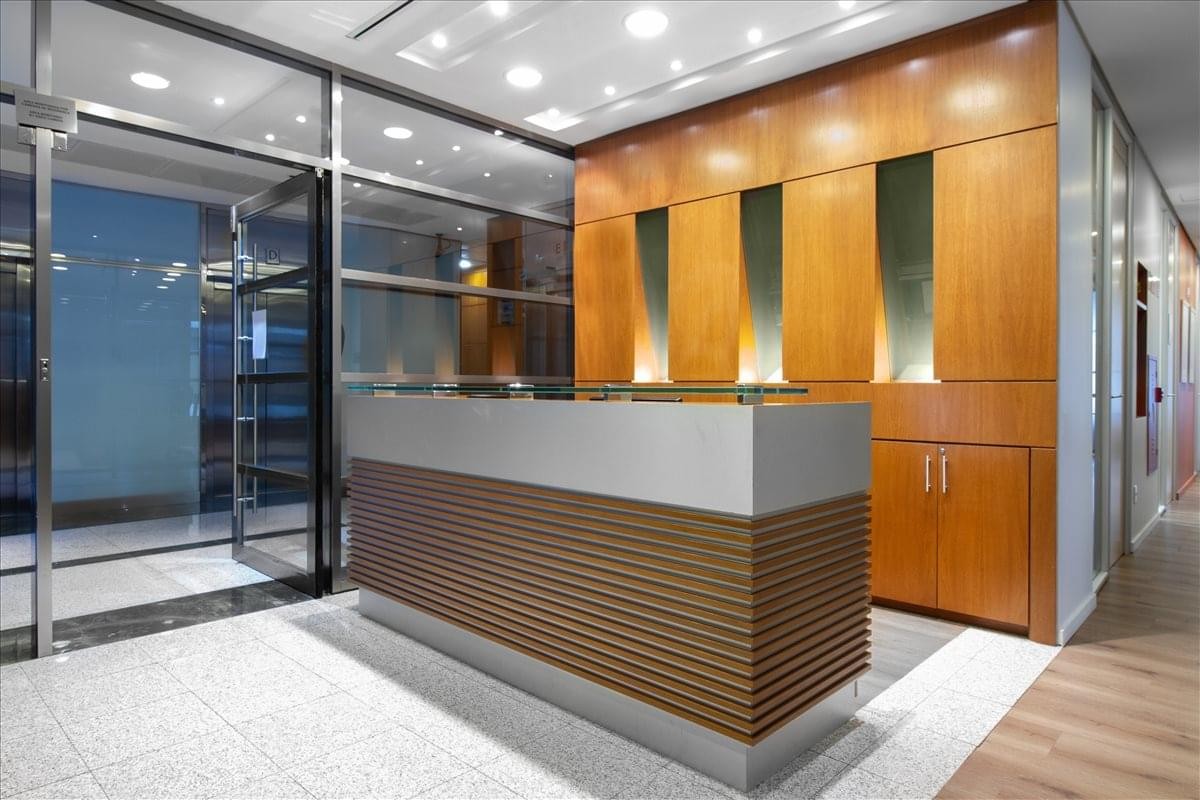 Sleek wood-paneled reception desk at Avenida Paulista, 1079, 7th and 8th floor, Sao Paulo, Brazil.