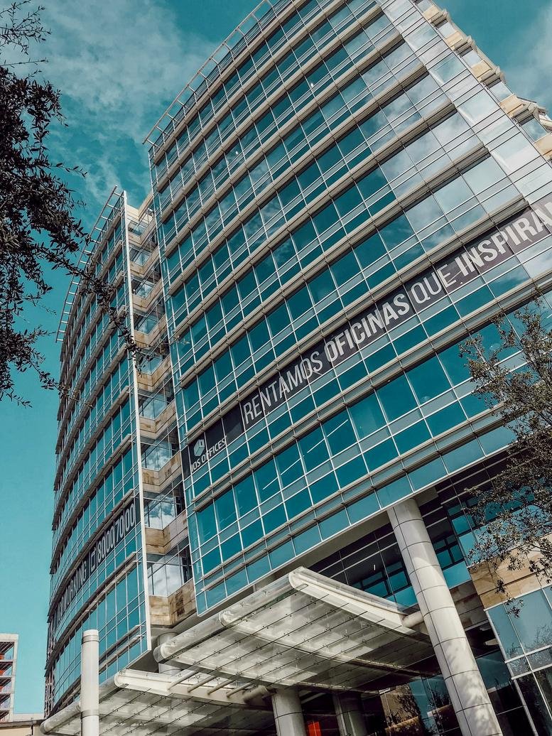 Exterior view of the glass-facade Avenida Roble 660, San Pedro Garza Garcia office building.