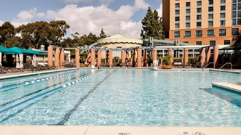 Sunny outdoor swimming pool area at Aventine, 8910 University Center Lane.
