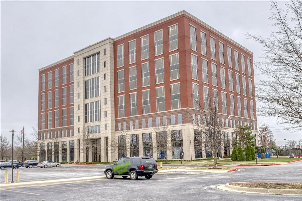 Exterior view of the brick and glass facade of the Bentonville Plaza building.