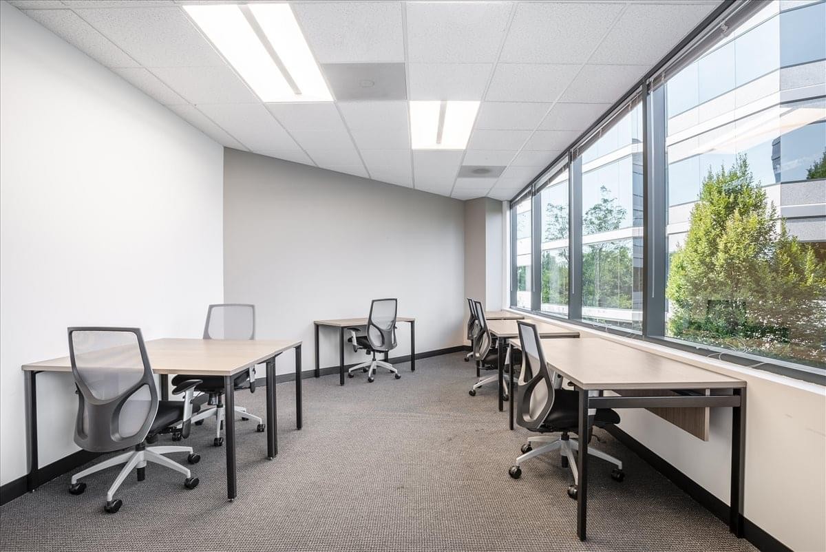 Spacious open-plan workspace at Bernal Corporate Park with rows of desks and large window views.