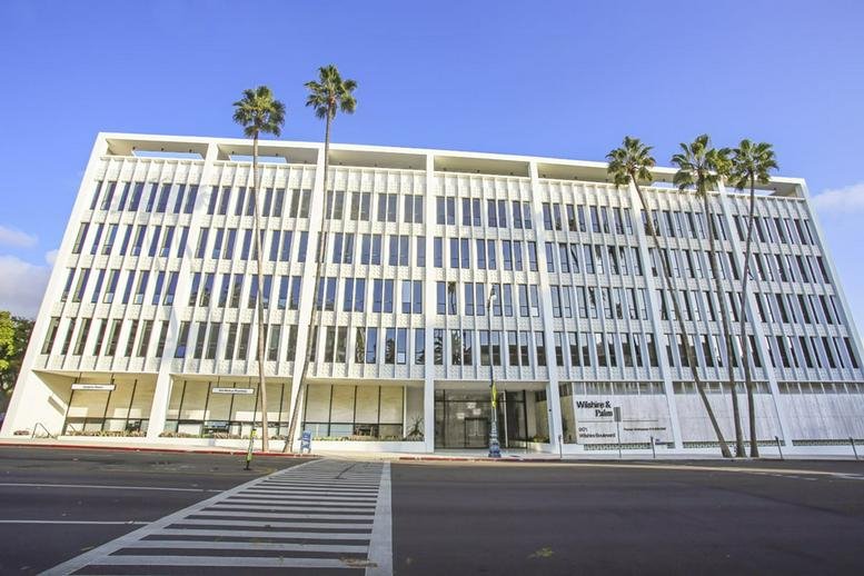 Exterior view of the white multi-story professional building at 9171 Wilshire Boulevard.