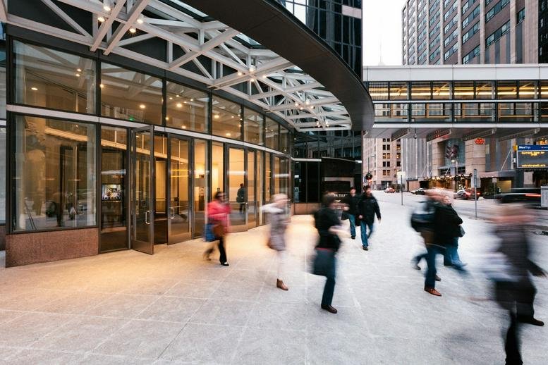 Exterior entrance of Capella Tower, 225 South 6th Street featuring glass walls and a modern canopy.
