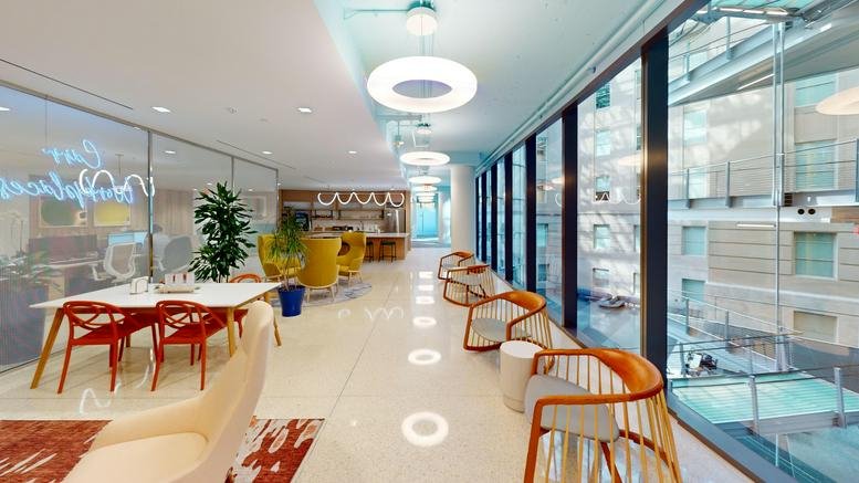 Spacious communal lounge at Capitol Hill Center, Suite 900, with modern lighting and floor-to-ceiling windows.