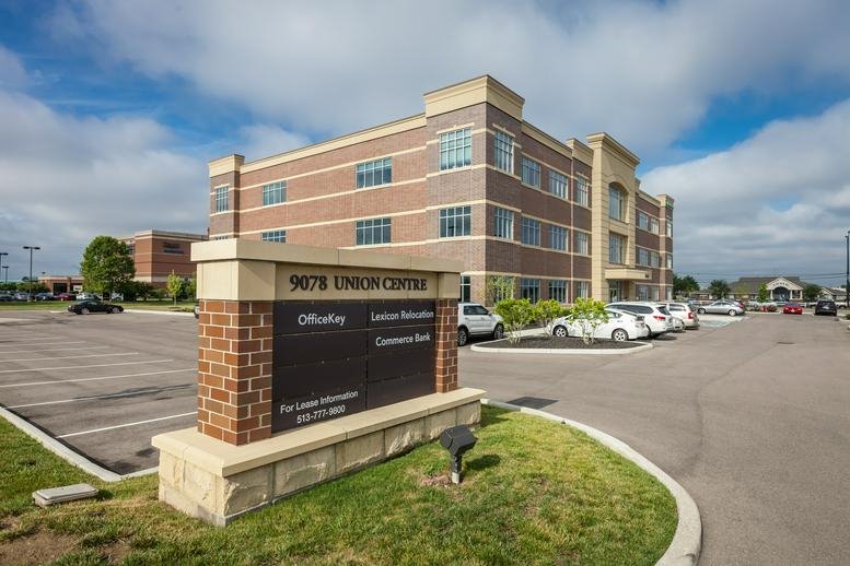 Exterior view of the brick and glass facade of 9277 Centre Pointe Drive.