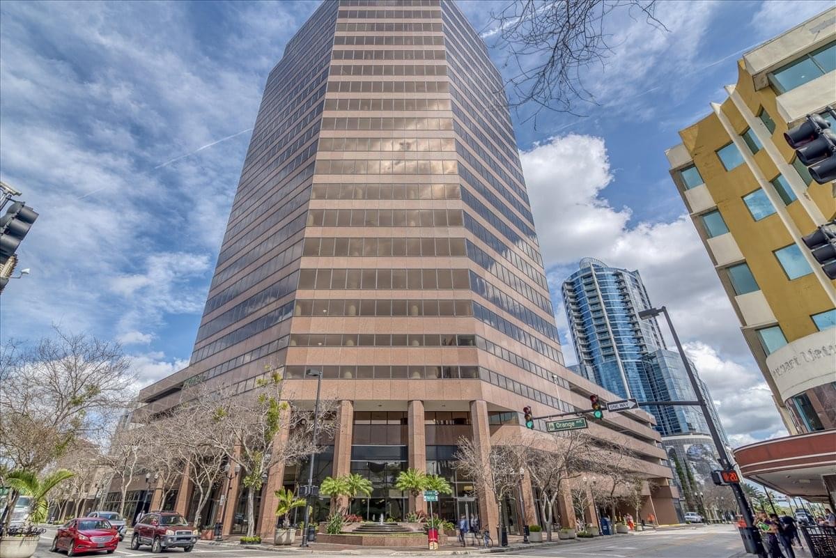 Exterior view of the high-rise Downtown North Orange building under a blue sky.