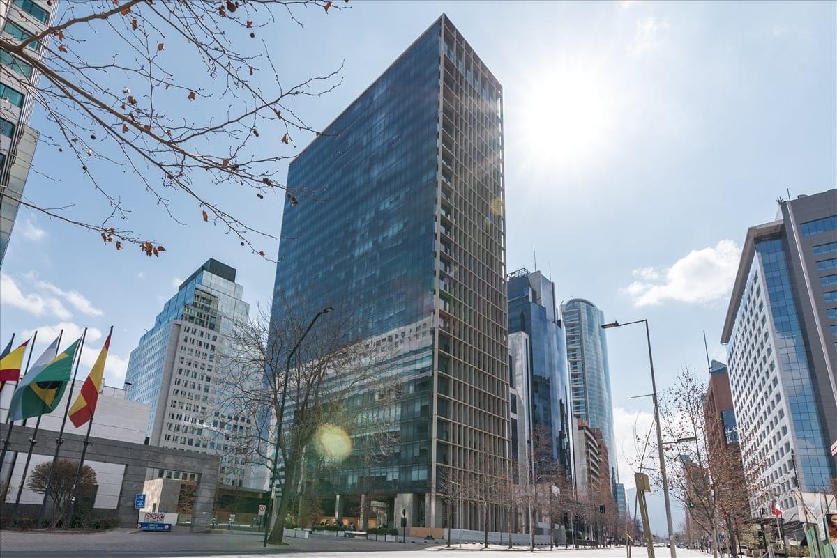 Exterior view of the glass-facade Edificio CCU against a bright sky.