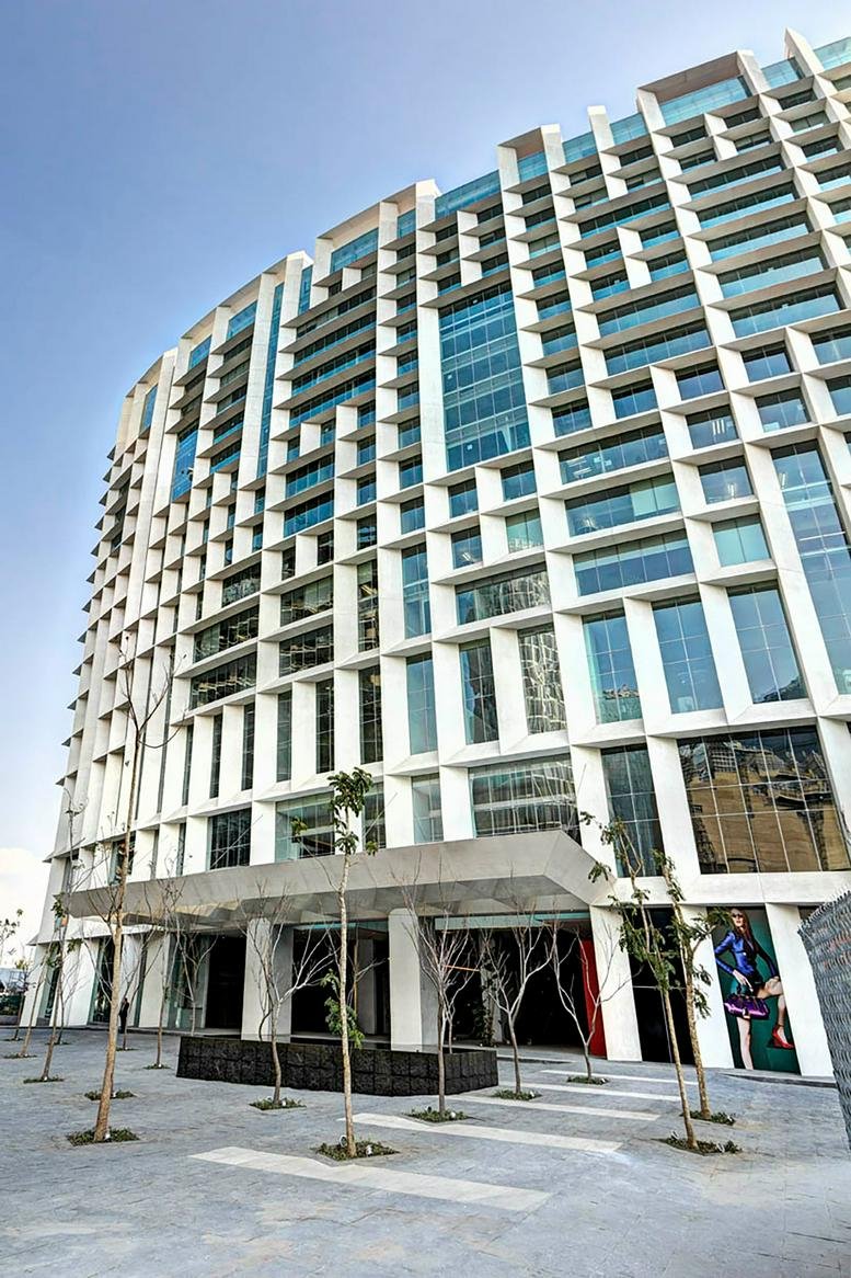 Modern architectural facade of Ejercito Nacional 843 with a distinctive white grid design.